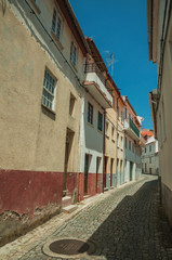 Colorful houses with wooden door on deserted alley