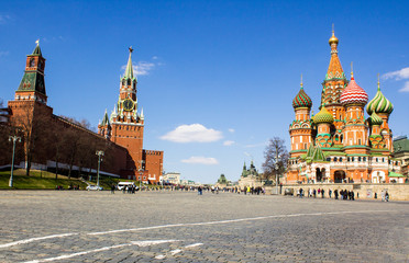 Moscow Kremlin and St. Basil's Cathedral on Red Square. View of the Spasskaya Tower and the Kremlin wall from Vasilyevsky descent. Tourist attraction of the capital of Russia on a sunny day.