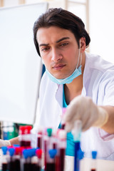 Young male chemist working in the lab 