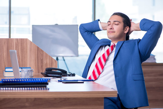 Young handsome businessman sitting in the office 