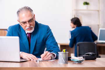 Young and old employees working together in the office 