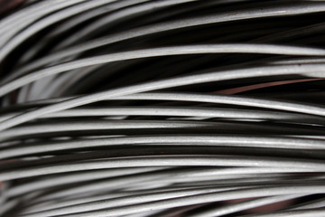 a coil of fechral thick refractory wire hangs in a warehouse of goods for ceramists. Frame of...