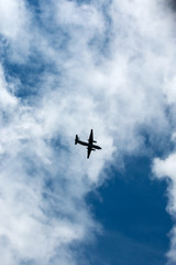 Fototapeta na wymiar the plane flies across the blue sky