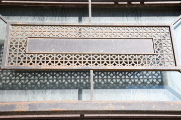 Grid metal rectangular gray as an element of decoration of the facade of the building. The architecture of the building.