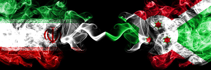 Iran vs Burundi, Burundian smoky mystic states flags placed side by side. Thick colored silky smokes flag combination of Iranian and Burundi, Burundian