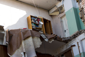 destruction by an explosion in a high-rise building. concept of natural disasters, anti-terrorism and the explosion of domestic gas. inaccessible bookcase