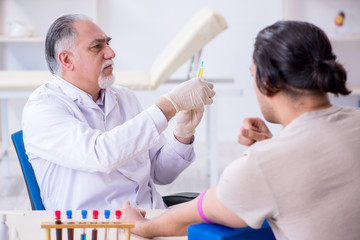 Young handsome man during blood test sampling procedure 