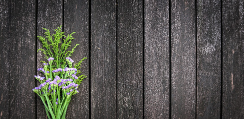 Wild flowers on wooden background