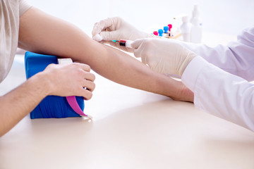 Young handsome man during blood test sampling procedure 