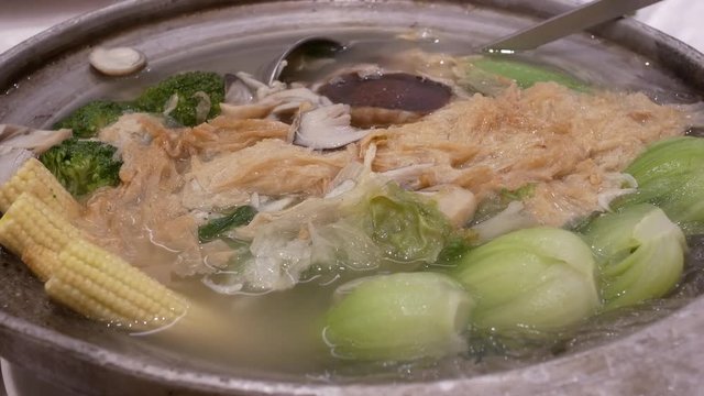 Motion of hot boiling soup with steam inside Chinese restaurant with 4k resolution
