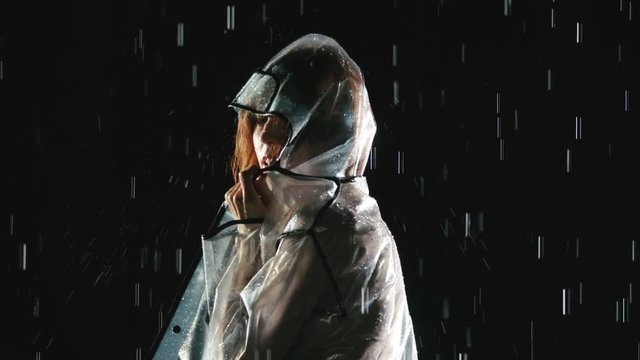 Beautiful woman dancing in the rain. Slow Motion.