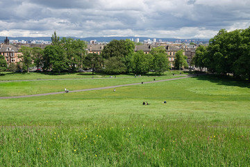 Queen’s Park in Glasgow, Scotland, is shown on a cloudy day. The park was developed in the 1800s, named in honor of Mary, Queen of Scots, and is a focal point of the local community.