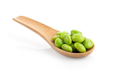 green soybeans in wood spoon isokated on white background