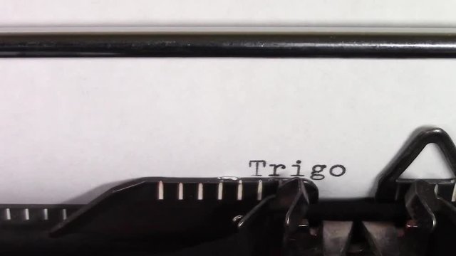 A close up video of the words "Trigonometry 101 " being typed on white paper in an old manual typewriter. Shot in macro.