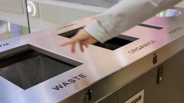 Motion of people throwing trash to the garbage can inside shopping mall with 4k resolution.