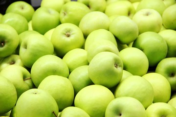 lots of green apples in the box, background. Good harvest.