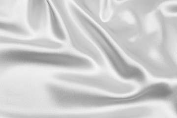 Fototapeta na wymiar The texture of the satin fabric of white color for the background