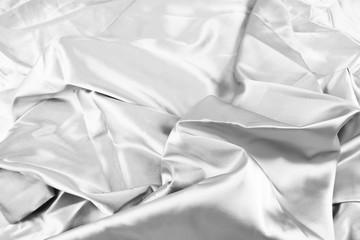 The texture of the satin fabric of white color for the background