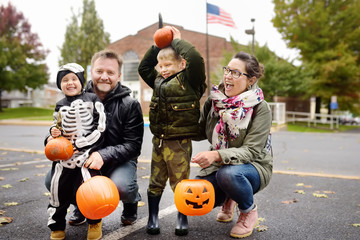 Family with two children on traditional party for celebrations halloween near New York.