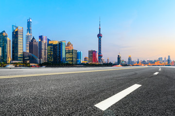 Fototapeta na wymiar Shanghai modern commercial buildings and empty asphalt road at sunset,China
