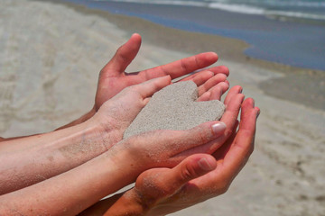 sand heart in hands