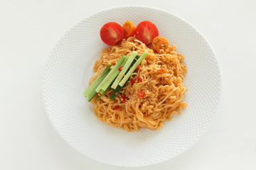 Asian food, mixed ramen noodles served with cucumber 