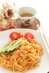 Asian food, mixed ramen noodles served with cucumber 