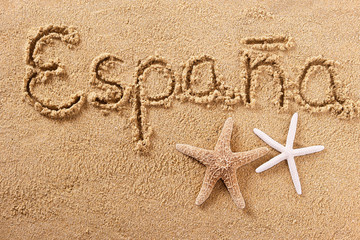 Espana word written in sand on a sunny spain spanish summer beach with starfish travel destination sign writing message photo