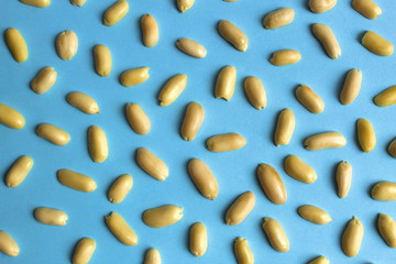 Texture peeled peanuts scattered on a blue background
