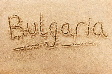 Bulgaria word written in sand on a sunny bulgarian summer beach holiday vacation travel destination sign writing message photo
