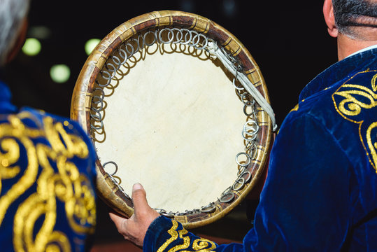 Doira at the Uzbek wedding. Round wooden musical drum. National Uzbek percussion instrument Doira.