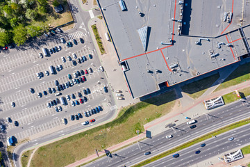 shopping mall of household goods with rows of cars on parking lot. aerial top view