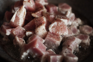 meat is fried in hot oil in a cast iron pot, roasted meat, meat preparation process, fried meat with spices