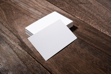 perspective view of white business card on wood floor