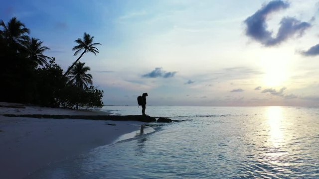 Sunset Over Maldives Island Beach, Woman Admiring vivid colors, Wide Shot With Copy Space