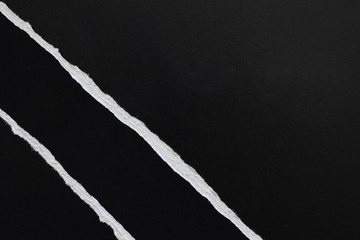 Ripped paper on black background, space for advertising copy.