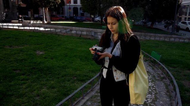 Young Latin tourist woman taking pictures in Madrid city centre