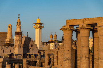 catholic Church and Muslim Mosque Tower religion Symbols together in Luxor temple at sunset