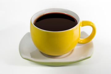Yellow cups with saucer filled with black coffee liquid Isolated white background