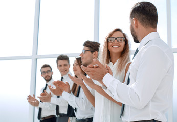 Fototapeta na wymiar happy business team applauds while standing in the office