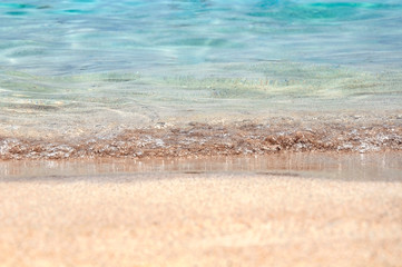 Ocean shore wet sand, blue water and waves. Vacation or relaxation concept