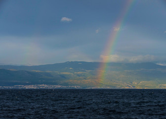 Beautiful rainbow over the sea horizon 