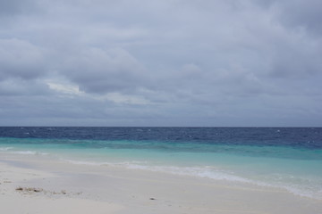 Empty beach in cloudy weather in the Maldives