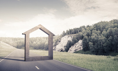 Conceptual background image of concrete home sign on asphalt road