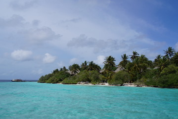 Cloudy sky over a tropical island resort on a sunny day