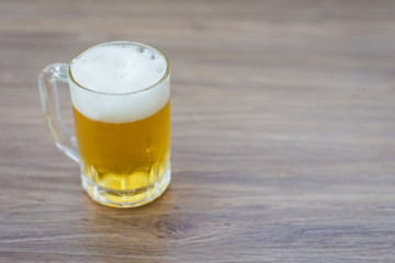 Beer in glass on wooden table