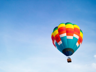 Hot air balloon in Flight with blue sky background
