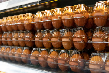 Packed eggs on the refrigerated display case in the supermarket