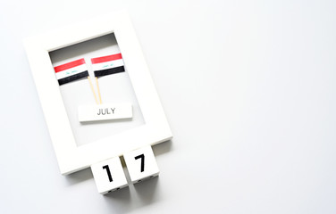 July 17 Wooden calendar and Iraq Flag Concept Iraq national day