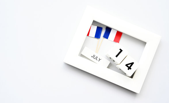 14 july Wooden calendar White background and French flag,Happy Bastille Day. Concept National Day France,Copy space,minimal style